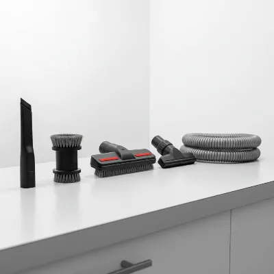 Various car detailing vacuum attachments and tools laid out neatly on a clean surface, emphasizing precision cleaning for tight spaces and upholstery.